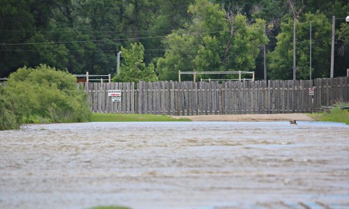 Floodwaters from the Assiniboine River flow over the driveway to Turtle Crossing Campground on June 30, just off Grand Valley Road. Following recent flooding in the region, the City of Brandon has taken steps to access emergency supports. (Matt Goerzen/The Brandon Sun)