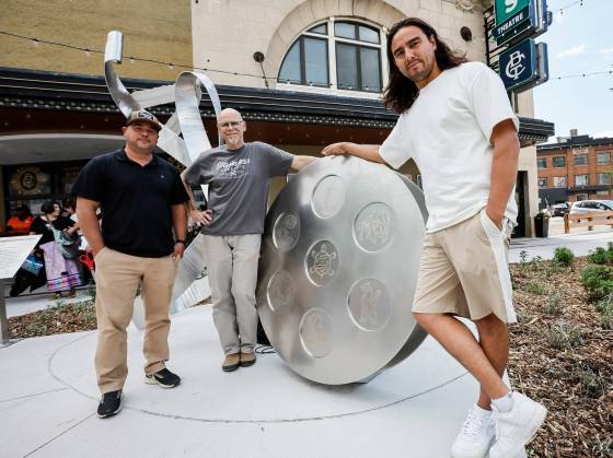 From left: Darren Sakwi and Rob Peristry of Stainless Concepts and artist Fredrick Spence with their creation, Gather Your Heart. (John Woods / Free Press)