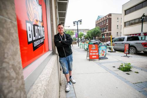 MIKAELA MACKENZIE / FREE PRESS 	 Eric Saniuk, owner of Blazing Chicken Shack on Graham Avenue, on Thursday, July 2, 2026. The fried chicken joint saw less customer traffic over the past year, likely due to buses being rerouted off Graham Avenue. For Gabby story. Free Press 2026