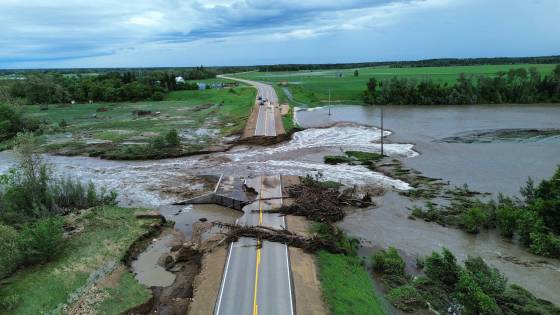 More than 50 provincial roads — including this section of Highway 10, north of Pine River — along with numerous municipal roads, remain damaged, flooded or washed out. (Government of Manitoba photo)