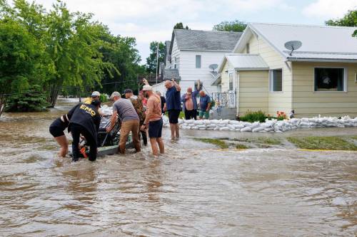 MIKE DEAL / FREE PRESS
                                Manitoba Premier Wab Kinew (left) helps a load a generator onto a canoe so it can be taken to a home only accessible by flooded streets in Swan River, MB. Manitoba Premier Wab Kinew flew to Dauphin, MB and Swan River, MB on Thursday to get a first hand look at some of the flood damage and to meet with officials and victims who are still in the midst of dealing with the situation. 260702 - Thursday, July 02, 2026.