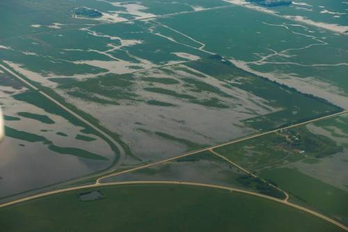 MIKE DEAL / FREE PRESS
                                Flooded farmland between Swan River, MB, and Winnipeg, MB. Manitoba Premier Wab Kinew flew to Dauphin, MB and Swan River, MB on Thursday to get a first hand look at some of the flood damage and to meet with officials and victims who are still in the midst of dealing with the situation. 260702 - Thursday, July 02, 2026.