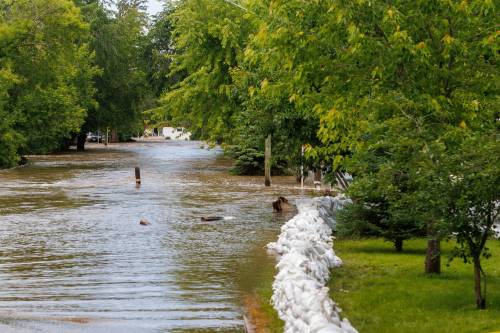 MIKE DEAL / FREE PRESS
                                Sixth Avenue North in Swan River was completely flooded Thursday.