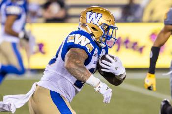 Winnipeg Blue Bombers&rsquo; Brady Oliveira (20) runs the ball during second half CFL football action against the Hamilton Tiger-Cats, in Hamilton on Sunday, July 5, 2026. (Nick Iwanyshyn / The Canadian Press)