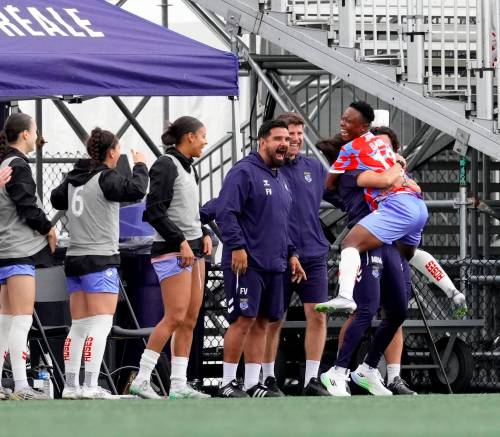 Vitor Munhoz / Northern Super League
                                Evelyn Badu leaps into the arms of her teammate at Stade Boréale. Badu had a hat trick last Saturday against the Vancouver Rise.