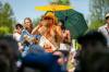 BROOK JONES / FREE PRESS
                                Folk Fest attendee Jayme Halbritter, 34, from Minneapolis, Minn., takes a sip of water while holding a parasol to try to keep cool on an extremely hot summer day while Yagódy performs on the Snowberry Field Stage at the Winnipeg Folk Festival at Birds Hill Provincial Park on Sunday.