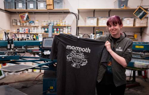 Dorian Preston photo
                                Samantha Wiebe, art director at HD Graphics, holds a Mammoth rock band tour T-shirt at the company&rsquo;s headquarters in Île-des-Chênes.