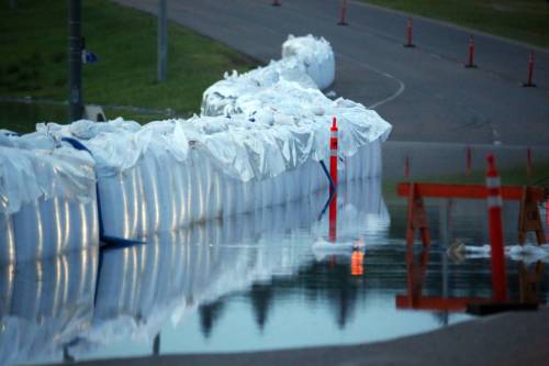 Matt Goerzen / Brandon Sun
                                Floodwater from the Assiniboine River seeps through a line of super sandbags along Brandon&rsquo;s First Street early Sunday morning.