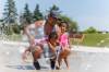 MIKE DEAL / FREE PRESS Joannes Mendivil and his two daughters, Pia, 2, and Paula, 1, take advantage of the cool water at the Maples Spray Pad Monday afternoon. Reporter: Tiago Resko 260713 - Monday, July 13, 2026.