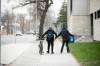 MIKAELA MACKENZIE / FREE PRESS FILES
                                A woman who was in distress is helped along Maryland Street near Gordon Bell High School in May.