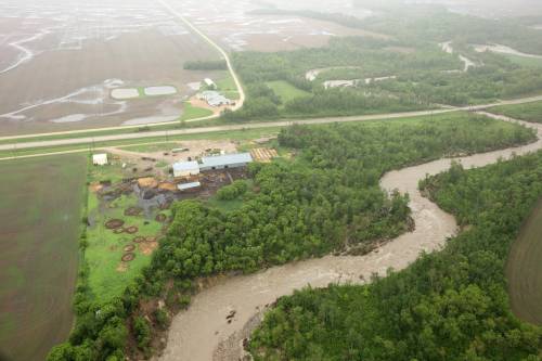 Tim Smith/The Brandon Sun 
                                Flooded farmland along Highway 10 between Minitonas and Swan River, Manitoba. Thirty five highways remain closed weeks after intense rainfall caused destructive flooding in several Manitoba communities.