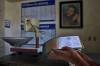 The Associated Press
                                A man shows his ration book, known as a &lsquo;libreta,&rsquo; backdropped by a framed image of Fidel Castro, at a state-run bodega in Havana, Cuba.