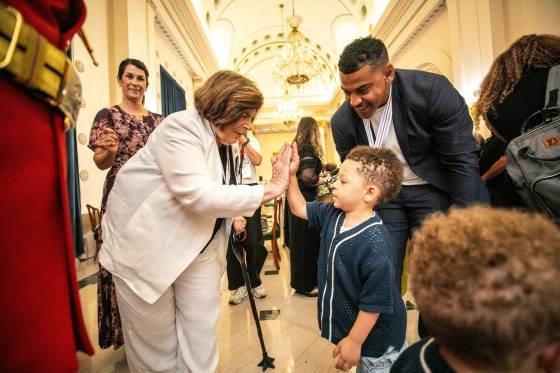 Lt.-Gov. Anita Neville (left) high-fives Axton Harris, age three, after his dad, Andrew Harris, was awarded the Order of Manitoba at the Manitoba Legislative Building on Thursday. (Mikaela MacKenzie / Free Press)