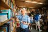 MIKAELA MACKENZIE / FREE PRESS
                                John Thompson at his pop-up Bookman stand on Friday. Fringe veterans often like to take a book along to shows so they can read while waiting for the curtain to lift.