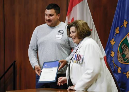JOHN WOODS / FREE PRESS
                                Rescue award recipient Preston Waide Houle is presented with a lifesaving award from the lieutenant governor Anita Neville at the Lifesaving Society Manitoban Awards in Government House Tuesday, July 28, 2026. reporter: morgan
