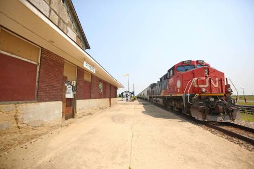 A Canadian National train passes by the aging train station in Rivers, Man. on a hot Wednesday afternoon. (Matt Goerzen/The Brandon Sun)
