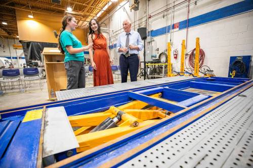 MIKAELA MACKENZIE / FREE PRESS 	 Cassandra Foy, final year collision, repair and refinishing program student (left), Rene Cable, minister of advanced education, and Lloyd Schreyer, RRC Polytech board chair, check out the car-o-liner that MPI donated to RRC Polytechճ collision repair and refinishing program on Thursday, July 30, 2026. For Gabby story. Free Press 2026