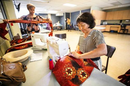 MIKAELA MACKENZIE / FREE PRESS
                                Volunteer sewer Zhimin Yang works to replace the stolen cultural costumes at the Notre Dame Recreational Centre Friday.
