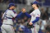 Texas Rangers catcher Elias Díaz (35) shakes hands with pitcher Jacob Latz, right, after the Rangers defeated the Miami Marlins in a baseball game, Monday, June 22, 2026, in Miami. (AP Photo/Lynne Sladky)