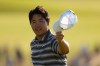 Tom Kim, of South Korea, waves after his putt on the 18th hole during the final round of the U.S. Open golf tournament at Shinnecock Hills Golf Club in Southampton, N.Y., Sunday, June 21, 2026. (AP Photo/George Walker IV)