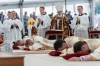 Four bishops lie on the floor as they are given episcopal consecration during a Mass in a tent set up outside the Society of St. Pius X seminary, in Econe, Switzerland, Wednesday, July 1, 2026. (Cyril Zingaro/Keystone via AP)