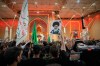 Mourners wave Shiite religious flags and a portrait of the late Iranian Supreme Leader Ayatollah Ali Khamenei outside the Imam Ali Shrine on the eve of funeral ceremonies in Najaf, Iraq, Tuesday, July 7, 2026. (AP Photo/Hadi Mizban)