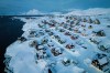 FILE - Houses covered in snow are seen on the coast of a sea inlet of Nuuk, Greenland, March 7, 2025. (AP Photo/Evgeniy Maloletka, File)