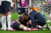 England's Jordan Henderson (14) is looked after by training staff following an injury in the postgame celebration in the World Cup round of 16 soccer match between Mexico and England in Mexico City, Sunday, July 5, 2026. (AP Photo/Eduardo Verdugo)