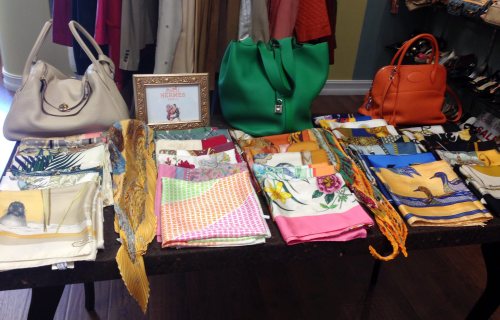 In this Feb. 22, 2016 photo, a variety of Hermes scarves and bags are displayed at the Serendipity consignment store in Boca Raton, Fla. The snowbird's paradise has a thriving high-end consignment market for their designers and ofter barely worn castoffs. (AP Photo/Kelli Kennedy)