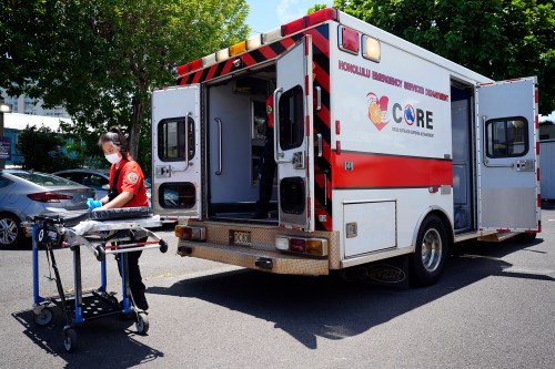 Honolulu C.O.R.E. team EMT Taylor Kodani cleans a gurney after transporting a homeless patient from Kaimuki Community Park, Aug. 19, 2024, in Honolulu. (Kevin Fujii/Civil Beat via AP)
