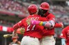 Cincinnati Reds' Elly de la Cruz, right, celebrates with Sal Stewart, left, after hitting a two-run homer during the fourth inning of a baseball game against the Philadelphia Phillies in Cincinnati, Wednesday, July 8, 2026. (AP Photo/Carolyn Kaster)