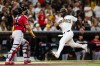 San Diego Padres' Luis Campusano, right, heads home to score on a double hit by Miguel Andujar against the Arizona Diamondbacks in the fourth inning of a baseball game Wednesday, July 8, 2026, in San Diego. (AP Photo/Derrick Tuskan)