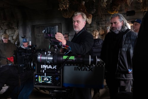 This image released by Universal Pictures shows director Christopher Nolan, center, with cinematographer Hoyte van Hoytema on set of 