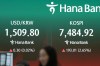 A dealer walks past near the screens showing the Korea Composite Stock Price Index (KOSPI) and the foreign exchange rate between U.S. dollar and South Korean won at a dealing room of Hana Bank in Seoul, South Korea, Friday, July 10, 2026. (AP Photo/Lee Jin-man)