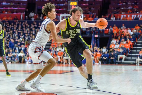 Oregon centre Nate Bittle drives against Illinois' Keaton Wagler during the second half of an NCAA college basketball game Tuesday, March 3, 2026, in Champaign, Ill. (AP Photo/Craig Pessman)