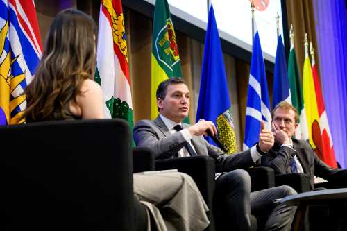 Evan Solomon, Minister of Artificial Intelligence and Digital Innovation and Minister responsible for the Federal Economic Development Agency for Southern Ontario, centre, speaks during a Gen(Z)AI Plenary Convening fireside chat, while Marc Miller, Minister of Canadian Identity and Culture, right, looks on, in Ottawa, on Thursday, April 30, 2026. THE CANADIAN PRESS/Spencer Colby
