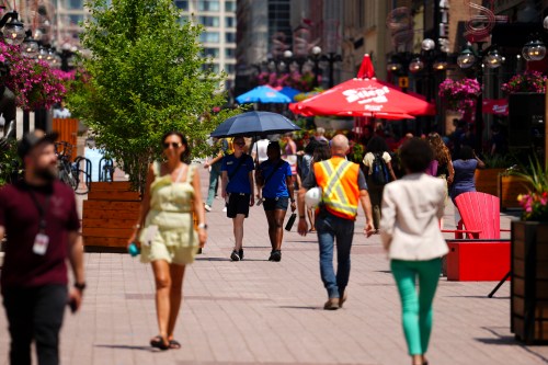 People make their way through downtown Ottawa on Tuesday, June 18, 2024. THE CANADIAN PRESS/Sean Kilpatrick