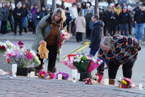 People bring flowers and stuffed animals to a vigil for the victims of a mass shooting, in Tumbler Ridge, B.C., Friday, Feb. 13, 2026. THE CANADIAN PRESS/Christinne Muschi