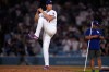 Los Angeles Dodgers' Shohei Ohtani fakes a pitch after the Dodgers defeated the against the Colorado Rockies in a baseball game Wednesday, July 8, 2026, in Los Angeles. (AP Photo/Mark J. Terrill)