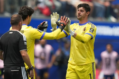 Belgium goalkeeper Thibaut Courtois, right, leaves the pitch after sustaining an injury during the World Cup quarterfinal soccer match between Spain and Belgium in Inglewood, Calif., near Los Angeles, Friday, July 10, 2026. (AP Photo/Andre Penner)