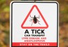 A sign advising hikers of ticks is shown on a trail in the woods in the Eastern Townships west of Montreal, Wednesday, Oct. 16, 2024. THE CANADIAN PRESS/Graham Hughes