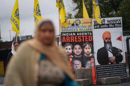 A photograph of late temple president Hardeep Singh Nijjar, back right, is seen outside the Guru Nanak Sikh Gurdwara Sahib, in Surrey, B.C., Tuesday, Oct. 15, 2024. Hardeep Singh Nijjar was assassinated in his vehicle while leaving the temple parking lot last year. THE CANADIAN PRESS/Darryl Dyck