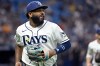Tampa Bay Rays third baseman Junior Caminero watches a replay on his way to the dugout after the final out of the top of the seventh inning of a baseball game against the Seattle Mariners, Friday, July 10, 2026, in St. Petersburg, Fla. (AP Photo/Jason Behnken)