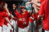 St. Louis Cardinals' JJ Wetherholt is congratulated by teammates after scoring a run during the sixth inning of a baseball game against the Atlanta Braves Friday, July 10, 2026, in St. Louis. (AP Photo/Scott Kane)