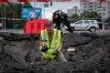 A sapper examines the impact site of a Russian missile in a residential area of Kyiv, Saturday, July 11, 2026. (AP Photo/Dan Bashakov)