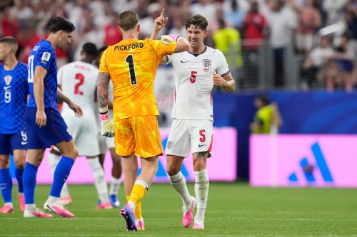 England's John Stones (5) and England goalkeeper Jordan Pickford (1) celebrate their team's fourth goal by England's Marcus Rashford during the World Cup Group L soccer match between England and Croatia in Arlington, Texas, near Dallas, Wednesday, June 17, 2026. (AP Photo/Tony Gutierrez)