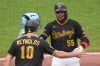 Pittsburgh Pirates' Esmerlyn Valdez (55) celebrates with Bryan Reynolds (10) after hitting a two-run home run off Milwaukee Brewers pitcher Shane Drohan during the fourth inning of the second game of a baseball doubleheader in Pittsburgh, Saturday, July 11, 2026. (AP Photo/Gene J. Puskar)