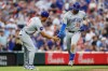 Chicago Cubs' Carson Kelly, right, celebrates his home run against Cincinnati Reds' Nick Lodolo during the sixth inning of a baseball game, Saturday, July 11, 2026, in Cincinnati. (AP Photo/Jay LaPrete)