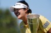 Haeran Ryu, of South Korea, celebrates with her trophy after winning the Evian Championship women's golf tournament, in Evian, eastern France, Sunday, July 12, 2026. (AP Photo/Laurent Cipriani)