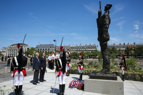 France's President Emmanuel Macron, center right, with Charles Dreyfus grandson of Alfred Dreyfus during a tribute ceremony to Captain Alfred Dreyfus on the first national day dedicated to the recognition of his innocence by the Court of Cassation in 1906, and the fight against the resurgence of antisemitism, 120 years later, on the Ile de la Cite near the Cour de Cassation in Paris, Sunday, July 12, 2026. (Thomas Samson/Pool Photo via AP)